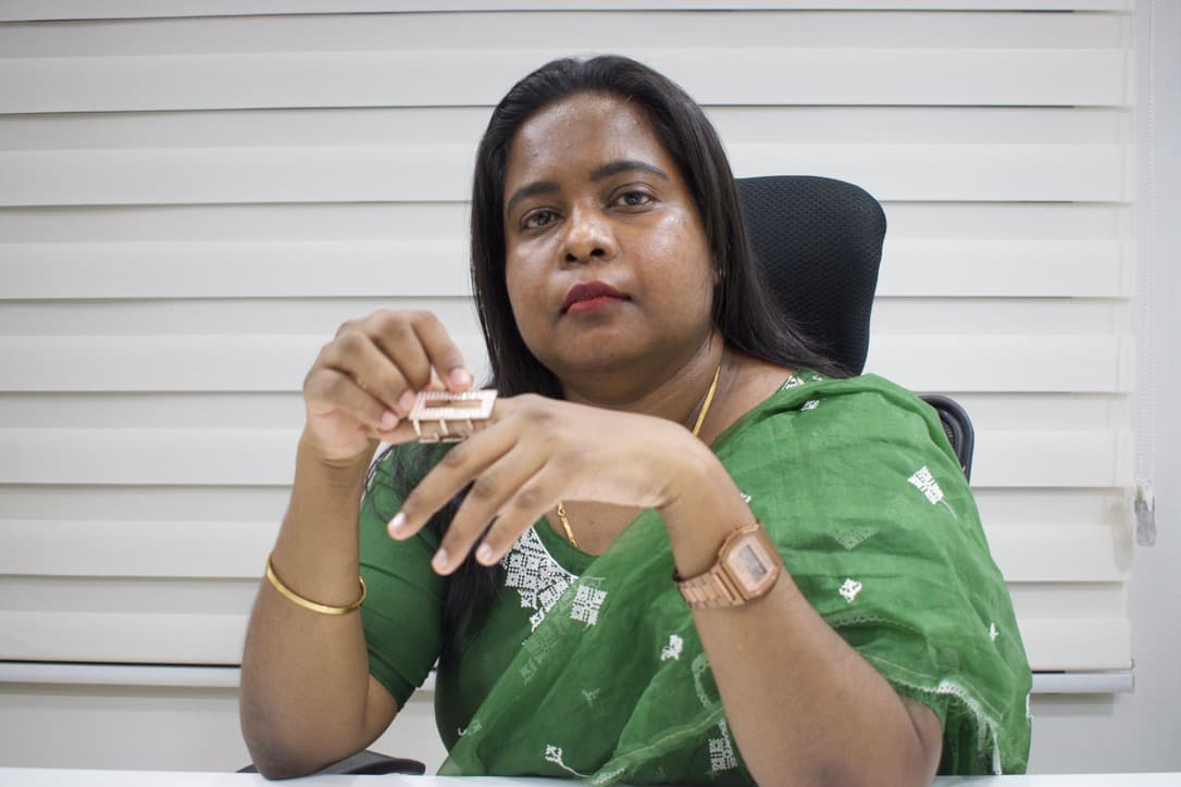 Dr. Ann Jenita examining a dermatological treatment tool, reflecting an evidence-based approach